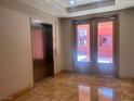 Condo lobby with elevator and doors leading outside at 87 E Agate Ave # 202, Las Vegas, NV 89123