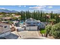Areal view of a blue two-story house with a pool and a trailer parked on a concrete driveway at 9436 Darwell Dr, Las Vegas, NV 89117
