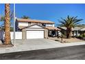 Charming two-story home featuring a well-manicured yard and two car garage on a sunny day at , Henderson, NV 89014
