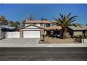 Traditional two-story home with a well-maintained yard, mature palm trees, and a two car garage at , Henderson, NV 89014