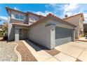 Two-story home features a red tile roof, two-car garage, and neutral stucco with desert landscaping at 10162 Lemon Thyme St, Las Vegas, NV 89183