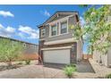 Charming two-story home with stone accents and a brick driveway at 10345 Zebra Swallowtail St, Las Vegas, NV 89141