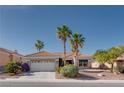 Charming single-story home with desert landscaping, tiled roof and a two-car garage at 10504 Button Willow Dr, Las Vegas, NV 89134