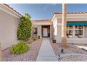 Inviting front entrance with lush landscaping, decorative plants and a well-lit walkway at 10504 Button Willow Dr, Las Vegas, NV 89134