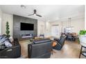 Bright, open-concept living space with a modern fireplace, dining area, and stylish furnishings at 10504 Button Willow Dr, Las Vegas, NV 89134