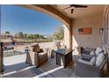 Covered patio with comfortable seating and a stone fire pit perfect for entertaining friends and Gathering at 10504 Button Willow Dr, Las Vegas, NV 89134