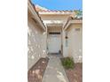 Welcoming entryway featuring a decorative 'HOME' sign, and easy-care landscaping at 1079 Oak Shade Ln, Henderson, NV 89015