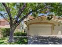 Inviting home exterior featuring a well-manicured lawn, shade trees, and a spacious two-car garage, showcasing great curb appeal at 108 Broken Rock Dr, Henderson, NV 89074