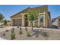Inviting front exterior featuring desert landscaping and a well-maintained facade under a clear sky at 12438 Heritage Bend Dr, Las Vegas, NV 89138