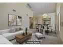Bright living room with modern decor and an open floor plan to the dining area at 1305 Chaparral Summit Dr, Las Vegas, NV 89117