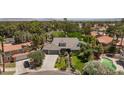 Expansive aerial view of a single-Gathering home with a pool, lush landscaping, and a three-car garage at 2222 Lucerne Ct, Henderson, NV 89014