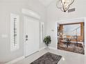 Bright foyer with high ceilings, tiled floor, and elegant chandelier, leading to a spacious office at 2222 Lucerne Ct, Henderson, NV 89014