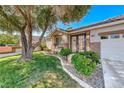 Inviting front yard featuring lush lawn and decorative landscaping details at 2544 Ashley Rose Ter, Henderson, NV 89052