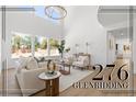 Bright living room with hardwood floors, high ceilings, and large windows at 276 Glenridding St, Las Vegas, NV 89183