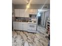 Bright kitchen with white cabinets, modern appliances, and marble flooring at 324 Princeton St, Las Vegas, NV 89107