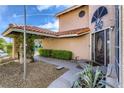 Inviting front entrance with a covered walkway, desert landscaping, and decorative door at 3355 Royal Bay Dr, Las Vegas, NV 89117