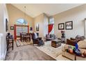 Spacious living room with vaulted ceilings, large windows, and comfortable seating area at 3355 Royal Bay Dr, Las Vegas, NV 89117