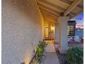 Inviting front entryway with decorative door, desert landscaping, and stone pillars at 353 Templeton Dr, Henderson, NV 89074