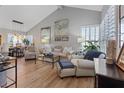 Bright and airy living room with vaulted ceilings, neutral decor, and hardwood floors at 353 Templeton Dr, Henderson, NV 89074