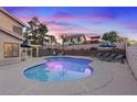 Backyard pool area with lounge chairs, mature landscaping, and a serene atmosphere at 353 Templeton Dr, Henderson, NV 89074