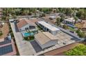 Aerial view of a home featuring a pool, detached garage, basketball court, and desert landscaping at 3630 Tobias Ln, Las Vegas, NV 89120