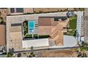 Aerial view of a home featuring a pool with desert landscaping, detached garage, and solar panels at 3630 Tobias Ln, Las Vegas, NV 89120