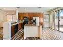 Bright kitchen with granite countertops, island, stainless steel appliances and wood cabinets at 3636 Remington Grove Ave, North Las Vegas, NV 89081