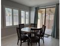 Cozy dining area with a round table, seating for four, and sliding door access to the patio at 3720 Rocklin Peak Ave, North Las Vegas, NV 89081