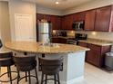 Modern kitchen featuring granite countertops, stainless steel appliances, and a breakfast bar at 3720 Rocklin Peak Ave, North Las Vegas, NV 89081