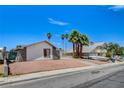 A single-story home with gravel yard, palm trees, and a view of the street at 4484 Bennett Dr, Las Vegas, NV 89121