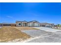 Beautiful home exterior featuring a wide driveway and minimalistic desert landscaping at 4781 Stoneham, Pahrump, NV 89061