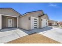 Close-up view of a modern home's entrance and spacious three-car garage at 4781 Stoneham, Pahrump, NV 89061