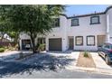 Attractive two-story home with a convenient attached garage, spacious driveway, and mature shade tree at 5330 E Charleston Blvd # 2, Las Vegas, NV 89142