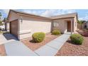 Single-story home with desert landscaping, a walkway to the front door, and an attached two-car garage at 5751 Mabel Rd, Las Vegas, NV 89110