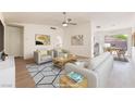 Bright, modern living room with neutral tones, ceiling fan, and comfortable seating arrangement at 5751 Mabel Rd, Las Vegas, NV 89110