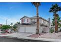 Charming two-story home with three-car garage, solar panels, desert landscaping, and palm trees at 5823 Rose Sage St, North Las Vegas, NV 89031