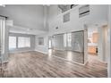 Bright and airy living room with high ceilings, wood-look floors, and lots of natural light at 5823 Rose Sage St, North Las Vegas, NV 89031