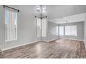 Spacious, open living room with soaring ceilings, wood-look flooring, and lots of natural light at 5823 Rose Sage St, North Las Vegas, NV 89031