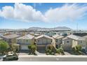 A neighborhood of charming homes with an expansive view of distant mountains under a vast sky at 6322 Angora Peak Ln, Las Vegas, NV 89115