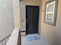 Exterior entrance featuring a welcome mat and textured stucco walls, plus a window at 6650 W Warm Springs Rd # 2159, Las Vegas, NV 89118