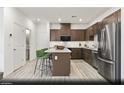Modern kitchen featuring stainless steel appliances, a central island, and ample cabinet space at 6740 Nimbus Ave # Lot 10, Las Vegas, NV 89130