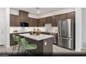Modern kitchen featuring stainless steel appliances, a central island, and ample cabinet space at 6740 Nimbus Ave # Lot 10, Las Vegas, NV 89130