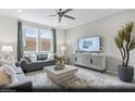 Bright living room with stylish decor, large windows, and a comfortable seating area at 6740 Nimbus Ave # Lot 10, Las Vegas, NV 89130