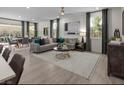 Bright and airy living room with modern furniture, stylish decor, and ample natural light at 737 Wild Highlands Ln, Henderson, NV 89015