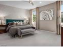 Elegant main bedroom featuring a decorative accent wall, sitting area, and ample natural light at 737 Wild Highlands Ln, Henderson, NV 89015