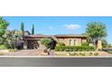 Charming single-story home with manicured landscaping, brick driveway, and inviting curb appeal at 748 Puerto Real Ct, Las Vegas, NV 89138