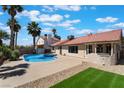 Inviting backyard featuring a sparkling swimming pool, lush greenery and a covered patio for outdoor entertaining at 8000 Vista Twilight Dr, Las Vegas, NV 89123
