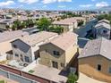 Aerial view of a residential neighborhood with similar homes, paved streets, and mountain views at 9543 Havasu Canyon Ave, Las Vegas, NV 89166