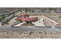 Aerial view of a large estate with red tile roof and palm trees, surrounded by a white perimeter fence at 10280 W La Mancha Ave, Las Vegas, NV 89149