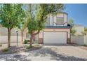 Charming two-story home with a two-car garage, brick driveway, and landscaped front yard at 10360 Cherry Brook St, Las Vegas, NV 89183